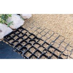 a black grate sitting on top of a pile of gravel