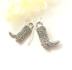 "🤠 Saddle Up in Style with Our Cowboy Boot Charm Earrings! 🤠 Yeehaw, cowgirl! Embrace your inner rodeo queen with our delightful Cowboy Boot Charm Earrings. Handcrafted with love and attention to detail, these earrings feature adorable miniature cowboy boots that dangle playfully from your ears. Key Features: 🌟 Charming Design: These earrings boast intricately designed cowboy boot charms, capturing the essence of the Wild West in every detail. 🌟 Quality Craftsmanship: Expertly crafted with h Nickel-free Western Style Earrings, Nickel-free Adjustable Western Earrings, Adjustable Nickel-free Western Earrings, Wild West Fashion, Boot Charm, Boot Charms, Texas Western, Rodeo Queen, Cowgirl Boot