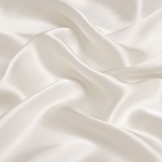 19mm silk satin fabric, 114cm wide, ivory white color. 100％ silk. How to care silk fabric: Washing: hand washing is advice 30 degrees, silk is a nature protein fiber so don't use harsh detergents that contain bleaches or brighteners, use only PH neutral detergent. Soaking silk for any more than afew minutes should be avoided. Drying: don't wring or twist, roll in towel to extract water. Avoid drying silk in direct sunlight. Any questions or comments on silk fabric, please let us know. Satin Fabric Images, Brilliant White Fabric, Luxury White Silk Evening Dress, Silk White Blanket, Whitw Satin Wallpaper, Satin Wallpaper Silk Beige, Luxury White Silk Embroidered Fabric, Cotton Silk Clothing Fabric, White Fabric For Dresses