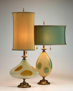 two lamps sitting next to each other on a table