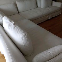 a white couch sitting on top of a hard wood floor