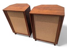 two wooden speakers sitting next to each other