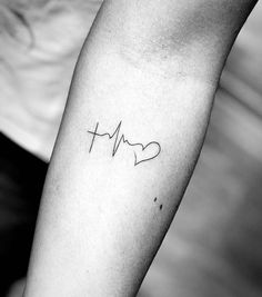 a black and white photo of a person's arm with a heartbeat tattoo on it