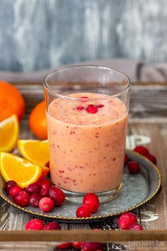 orange cranberry smoothie in a glass on a plate