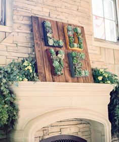 the fireplace is decorated with succulents and greenery