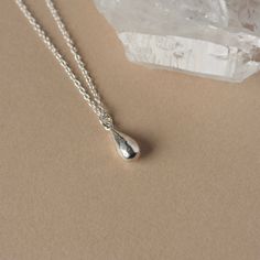 This elegant everyday necklace features a solid sterling silver teardrop charm. The small charm has a glossy polish and some subtle facets that add a bit of extra shine. Measuring 9mm in length and 4mm in width, the petite charm slides smoothly along the sterling silver cable chain for a simple and chic design that goes with everything. The necklace looks great worn solo but it's also a perfect layering piece to pair with others. The necklace is fastened with a sterling silver spring ring clasp and you can choose your desired length from the drop-down menu above.  For more minimalist necklaces www.etsy.com/ca/shop/juliegarland/search?search_query=minimalist+necklace And to return to the store: www.etsy.com/ca/shop/juliegarland Dainty Jewelry Silver, Silver Drop Necklace, Country Rings, Necklace Simple, Small Charms, Everyday Necklace, Teardrop Necklace, Layering Necklace, Silver Spring