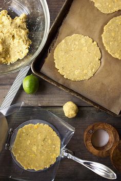 some food is sitting on top of a table next to a bowl and spatula