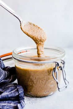 a spoon full of peanut butter being held up