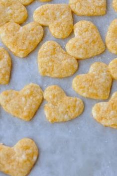 some heart shaped cookies are on a baking sheet