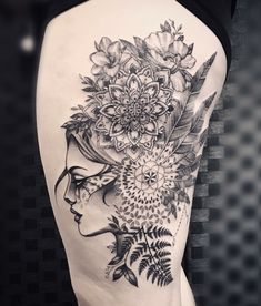 a woman's thigh with flowers and leaves on her head in black and white