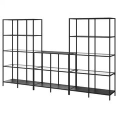 three black shelves with metal frames on each side and one shelf below them, both holding bookshelves