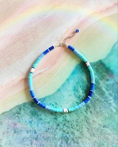 This is The Outer Shore Collection Tidal Blue Beaded Heishi necklace. This boho tropical surf style necklace is inspired by the Choker necklaces that Kiara wore on the Netflix series The Outer Banks. #summer #surfergirl #jewelry #choker #necklace #handmadejewelry #smallbusiness #giftforher Outer Banks Summer, Kiara Outer Banks, Boho Tropical, Heishi Necklace, Preppy Jewelry, Blue Clay, Polymer Beads, Diy Jewelry Unique, Surf Style