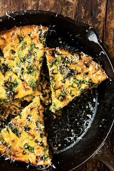 a skillet filled with food on top of a wooden table