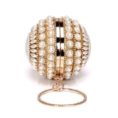 Make a statement with our Rollie Diamond Tassel Clutch. Spin into cocktail hour and have the time of your life. This diamond pearl is the ultimate lustrous party piece. Pair it with a little black dress or a power suit or maybe a wedding gown. Removable classic elbow chain Product dimensions: 12.5cm X 12.5cm Once purchased, this item will ship in 3-5 business days. For complete details, please read our Shipping Policy and Return & Exchange Policy. *****ALL SALES ARE FINAL***** Main material: Met Clutches Purse, Wedding Clutch Purse, Embellished Purses, Pearl Clutch, Wedding Handbag, Party Handbags, Beaded Evening Bags, Luxury Bracelet, Clutches For Women