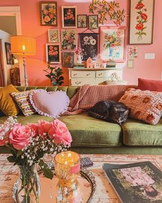 a living room filled with furniture and pictures on the wall