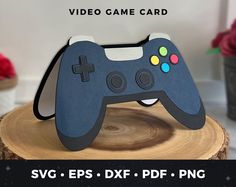 a video game controller cutout on top of a tree stump with the text svg eps dxf