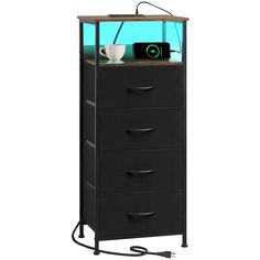 a tall black cabinet with drawers and an appliance in the bottom drawer that is connected to a phone