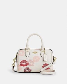 Refined pebble leather Two credit card slots Zip-top closure, fabric lining Handles with 2 3/4" drop Detachable strap with 23 1/2" drop for shoulder or crossbody wear 7" (L) x 4 3/4" (H) x 4" (W) Style No. CZ944 Coach Mini Rowan, Lips Print, Coach Outlet, Women's Bags, Christmas List, Coach Handbags, 4 H, Pebbled Leather, Fashion Bags