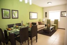 a living room with green walls and white tile flooring is pictured in this image