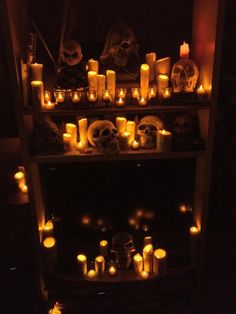 a shelf filled with candles and skulls