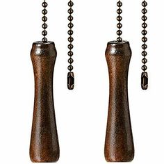 two wooden beads are hanging from the end of a chain