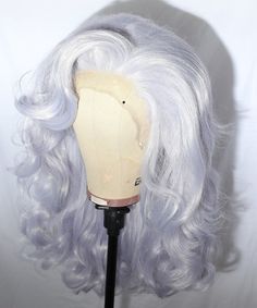 Transform into a vision of glamour with our Silver Lace Front Drag Wig. Crafted for performers who demand attention, this wig boasts luxurious volume and cascading curls that exude confidence and allure. Whether you're on stage or at a special event, this wig promises to elevate your look to dazzling heights. Silver Lace Front, Silver Wig, Cascading Curls, Silver Wigs, Drag Wigs, Exude Confidence, Voluminous Curls, Silver Lace, Silver Dragon