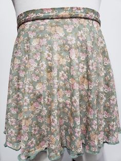 These pull on high, low, circle dance skirts are perfect for all your classed! The Color of the skirt is Sage, The Flowers are colored Cream, Pink, Dark Green and Light Brown. Pull on high, low,  circle Skirts are a great fast way to get the skirt on and go! The skirts have a flattering hemline and a sense of movement that is fun They are high in the front and lower in the back. They elongate the legs and look great on everyone! Dancers love this skirt because it is short enough to show correct Spring Fitted Skirt With Wide Waistband, Spring Stretch Skirt With Wide Waistband, Spring Skirt With Wide Waistband And Stretch, Fitted Maxi Skirt With Wide Waistband For Spring, Full Skirt With Wide Waistband And Flowy Fit, Flowy Summer Mini Skirt With Wide Waistband, Summer Flowy Mini Skirt With Wide Waistband, Spring Wide Waistband Mini Skirt, Flowy Mini Skirt With Wide Waistband For Summer