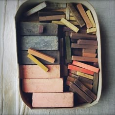 a tray filled with lots of different colored pencils