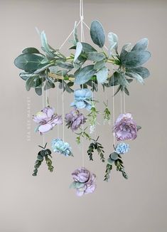 a mobile with flowers hanging from it's sides