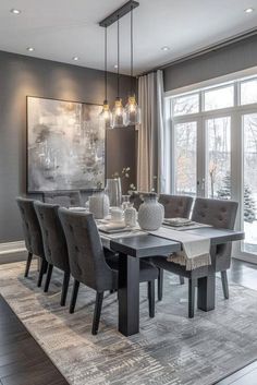 the dining room table is set with gray chairs