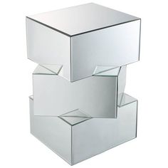 three mirrored cubes stacked on top of each other in the shape of an object