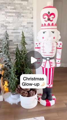 a large wooden nutcracker standing next to a christmas tree