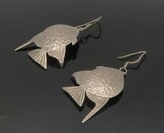 "MEXICO 925 Sterling Silver - Vintage Hammered Fish Motif Dangle Earrings- EG8498  MEXICO 925 Sterling Silver - Vintage Hammered Fish Motif Dangle Earrings- EG8498  Jewelry Type:         Earrings   Metal Type:            925 Silver  Metal Size:             2.5\"  Stone Type:            N/A  Condition:              N/A  Jewelry Weight:     13.1 Grams  PLEASE NOTE: THIS ITEM IS PRE-OWNED. ALTHOUGH MOST ITEMS ARE IN VERY GOOD CONDITION, SOME MAY NEED CLEANING AND/OR MINOR REPAIRS. WE MAKE A VERY STRONG EFFORT TO UPLOAD CLEAR PICTURES. PLEASE INSPECT ALL PICTURES AND ASK ALL QUESTIONS YOU MAY HAVE PRIOR TO MAKING A PURCHASE. NOT ALL STONES ARE GENUINE, SOME ARE ENHANCED OR CREATED." Fish Motif, Earrings Metal, Beautiful One, Types Of Metal, Metallic Silver, Etsy Gifts, Sell On Etsy, 925 Silver, Dangle Earrings