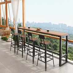 there are four bar stools at the top of this balcony with an amazing view