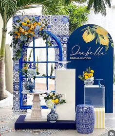 an assortment of vases and flowers on display in front of a blue sign with the words daffodila