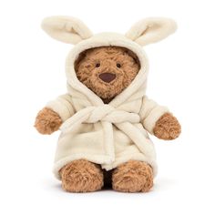 a teddy bear wearing a white robe and bunny ears on it's head, sitting in front of a white background