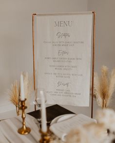 a menu sitting on top of a table next to candles