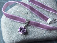 "Light purple velvet ribbon choker with sculpted dusky lilac shimmering rose. Material of rose is polymer clay with special cover Each petal of flower made by hand Dia flower about 15 mm/ 0.55 \" Length of necklace is adjustable: 10-12 inches/ 25,4 - 30,5 cm 11-13 inches/ 28-33 cm 12-14 inches/ 30.5- 35.5 cm 13-15 inches/ 33-38 cm 14-16 inches/ 35.5 cm-40.5 cm 15-17 inches/ 38,1 cm- 43,2 cm 16-18 inches/ 40.6 cm- 45.7 cm 17-19 inches/ 43 cm - 48 cm 18-20 inches 19-21 inches Width of ribbon 10 mm Purple Choker Necklace For Gift, Purple Rose Design Jewelry As Gift, Mauve Jewelry, Lilac Velvet, Ribbon Choker Necklace, Bridgerton Inspired, Ribbon Choker, Flower Choker, Womens Chokers