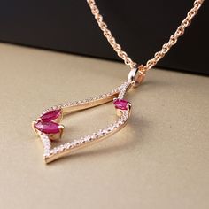 "** Vintage Inspired Ruby & Diamond Pendant** This amazing Ruby pendant is featuring three marquise cut Genuine Rubies (totaling .36cts) and surrounded on all sides by a Sparkling Bright Natural Diamonds (total Diamond weight is .20cts), all set in glowing 14k Rose Gold, hanging from an 18\" 14k Rose Gold chain. This beautiful Pendant has perfectly matching Earrings. **This listing includes the 18\" Loose Rope Chain. **Ruby is the official July Birthstone **Diamond is the official April Birt Rose Gold Ruby Jewelry With Diamond Accents, Rose Gold Teardrop Ruby Jewelry, Pink Ruby Marquise Jewelry, Pink Marquise Ruby Jewelry, Rose Gold Marquise Gemstone Jewelry, Ruby Diamond Pendant, Diamond Pendants, Ruby Pendant, Halo Pendant