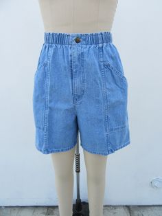 90s high waist denim shorts.  Light wash. All cotton. Elastic waist. Side pockets. Made in Mexico for CHEROKEE.  Label size Small Please compare measurements to a similar garment that fits you well Measured flat 25 to 30" elastic waist 40" hips 13-3/4" rise 6" inseam  Good + vintage condition with minimal signs of use and age. Retro High Waist Denim Shorts, Retro Short Denim Shorts, 90s Denim Blue Shorts With Pockets, Retro High-waist Denim Shorts, Retro High Waist Jean Shorts With Built-in Shorts, Retro High-waisted Jean Shorts With Built-in Shorts, Retro High Rise Cotton Shorts, 90s Inspired Denim Shorts, 90s High-waist Cotton Jean Shorts