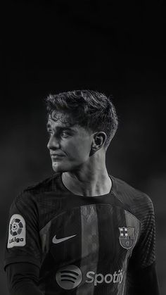 a black and white photo of a soccer player with his head turned to the side