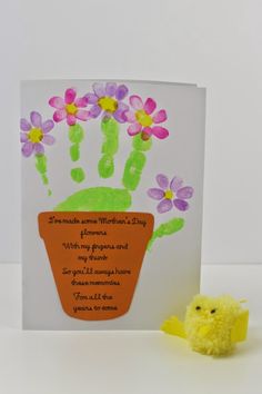 a small yellow chicky next to a handprinted card with flowers on it