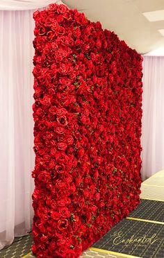 a large red flowered wall in the middle of a room