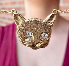 The "Meow Meow" pendant necklace captures the playful charm of a feline's face, with sparkling European brilliant crystals for eyes that twinkle with mischief. The 14K gold-dipped pendant hangs gracefully from a twisted 17" chain, secured with a lobster clasp for easy wear. This necklace is the purr-fect accessory for cat lovers who want to keep a touch of feline magic close to their hearts. 14K Gold Dipped Cat Face & Twisted Chain Round Clear & Brilliant European Crystals Measurements: 17"L x 1 Crystal Eyes, Twisted Chain, 1928 Jewelry, Crystal Eye, For Eyes, Meow Meow, Gold Dipped, Cat Face, Easy Wear