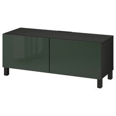 a green cabinet with two doors and black legs