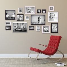 a red chair sitting in front of a wall filled with pictures