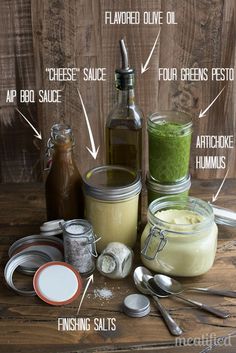 the ingredients to make green smoothie on a wooden table with spoons and jars