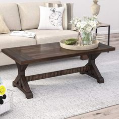 a coffee table sitting on top of a white rug