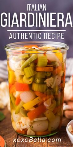 a jar filled with vegetables sitting on top of a wooden table