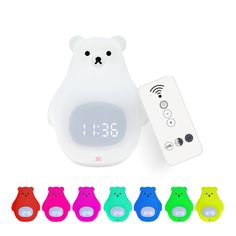 an alarm clock with different colors and shapes next to the remote control for each bear